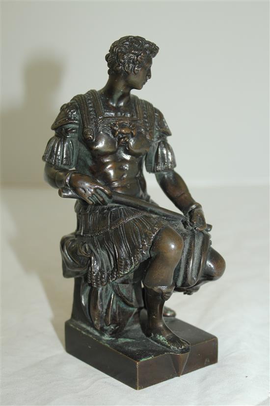 After the antique. A bronze model of a seated Roman soldier, inscribed Michel angelo, 6.5in, on separate marble plinth